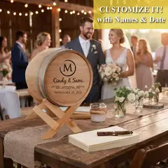 Custom engraved wedding card barrel with couple names and wedding date displayed on a rustic reception table during a wedding celebration.