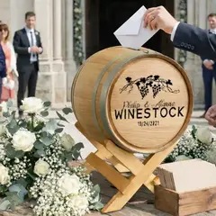 Guest placing envelope into rustic wedding card barrel at outdoor wedding ceremony entrance