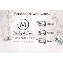 Wedding guest writing a message in a guest book beside a personalized wedding card barrel used for collecting wedding cards and envelopes.