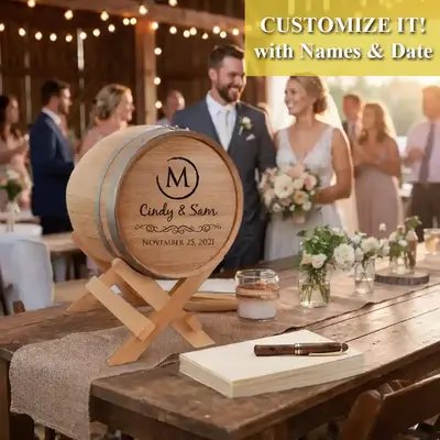 Custom engraved wedding card barrel with couple names and wedding date displayed on a rustic reception table during a wedding celebration.