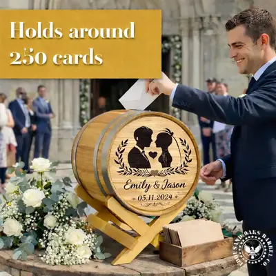 Personalized oak wedding card holder barrel with engraved names displayed on wooden stand at wedding reception table.
